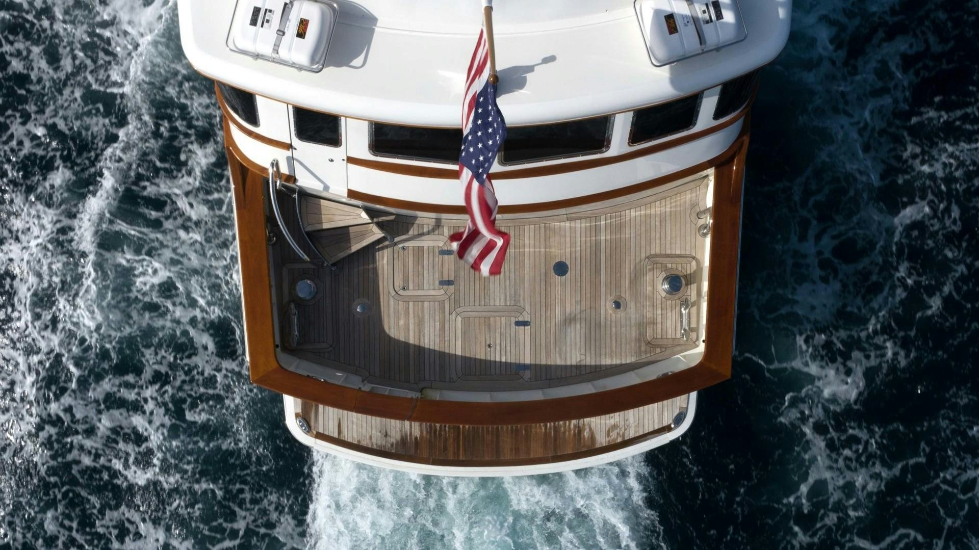 a white car with a flag on it aboard NEREUS Yacht for Sale