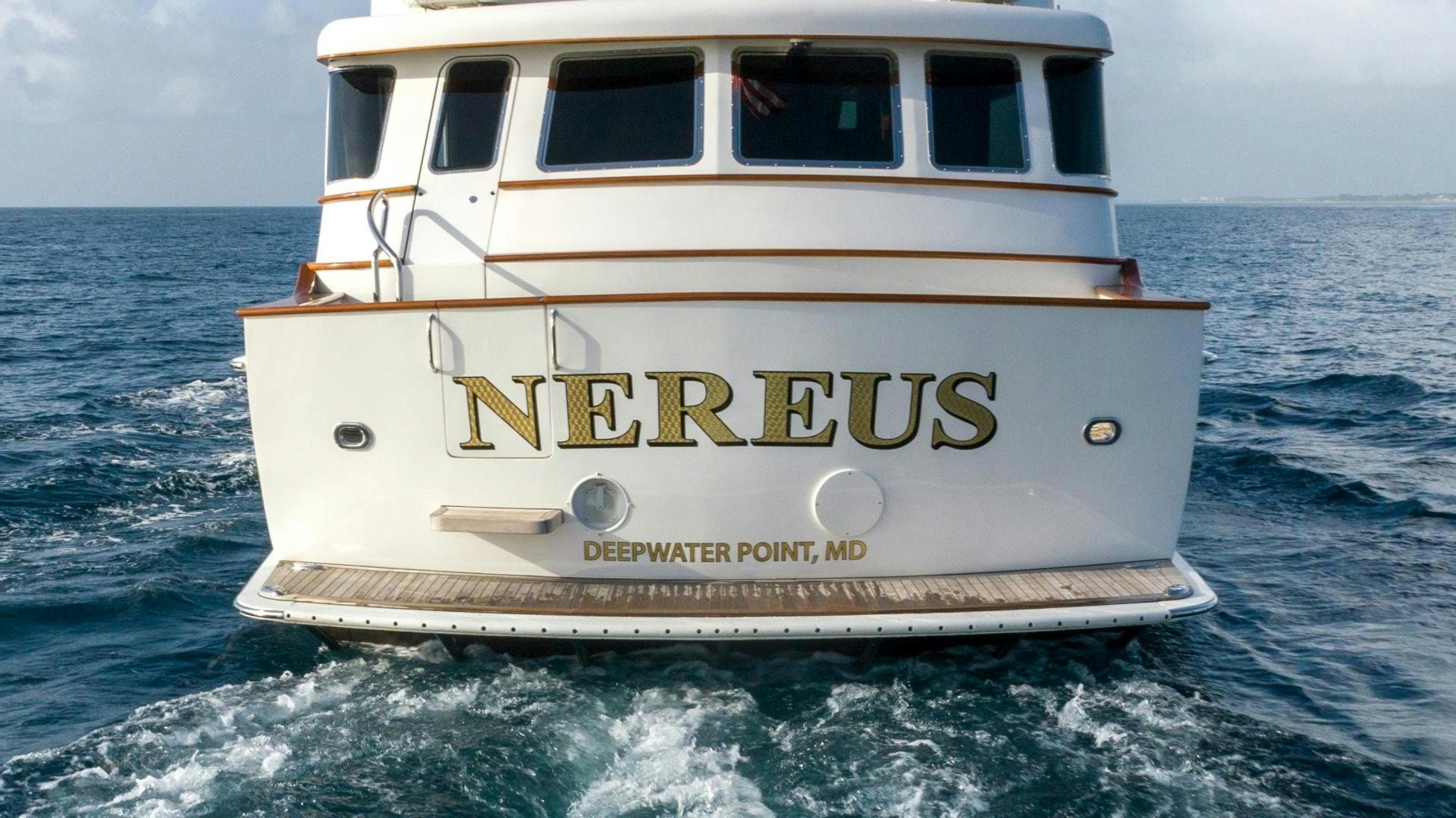 a white boat in the water aboard NEREUS Yacht for Sale