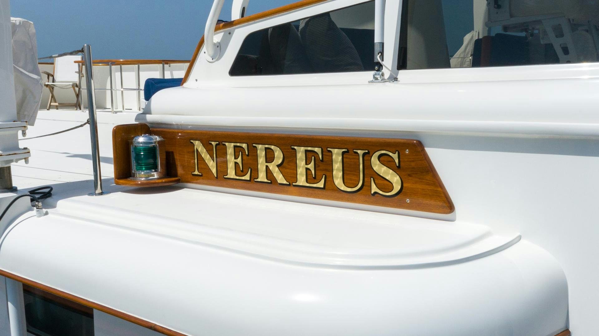 a white boat with a sign on it aboard NEREUS Yacht for Sale