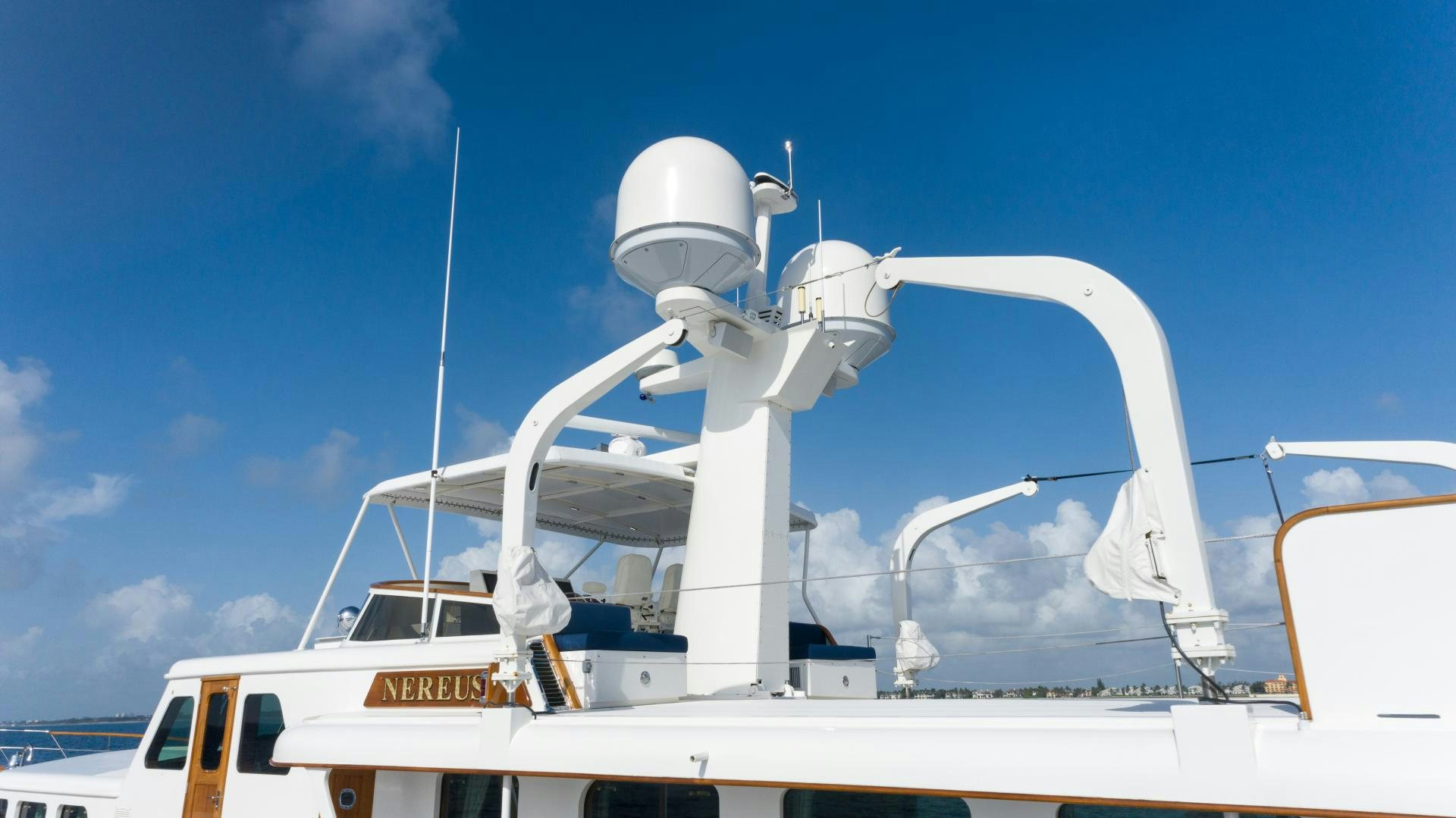 a white boat with a satellite dish on top aboard NEREUS Yacht for Sale