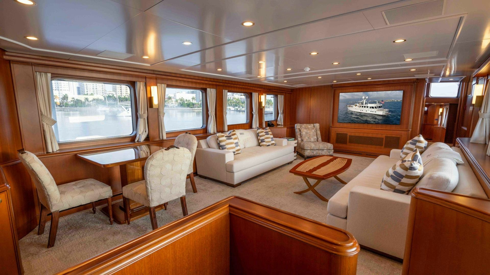 a living room with a couch and a table aboard NEREUS Yacht for Sale