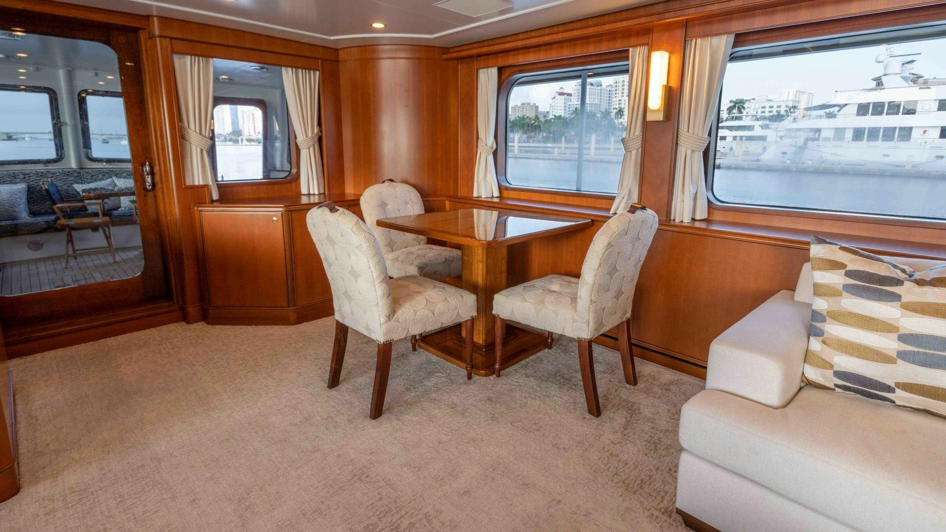 a room with a table chairs and a window aboard NEREUS Yacht for Sale