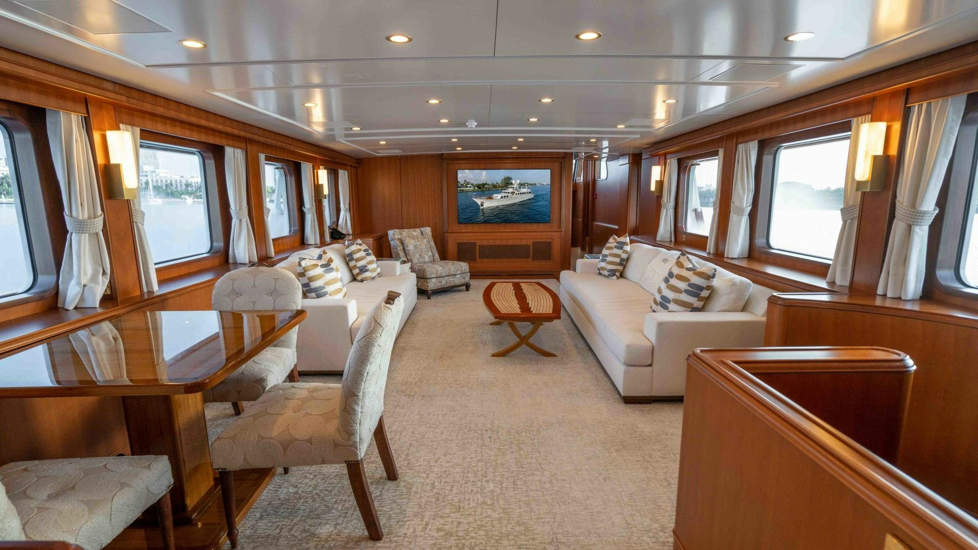 a living room with a couch and a television aboard NEREUS Yacht for Sale