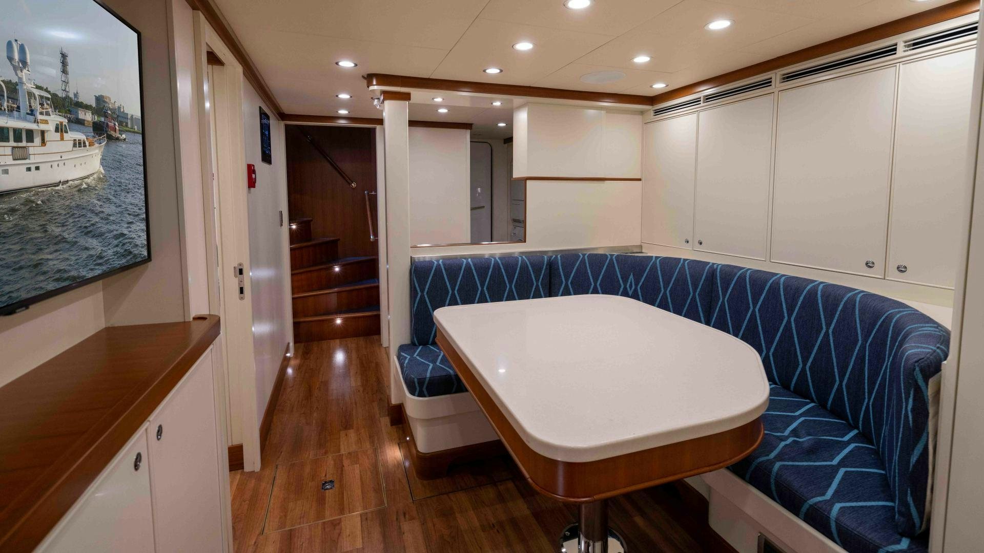 a large white table in a room aboard NEREUS Yacht for Sale