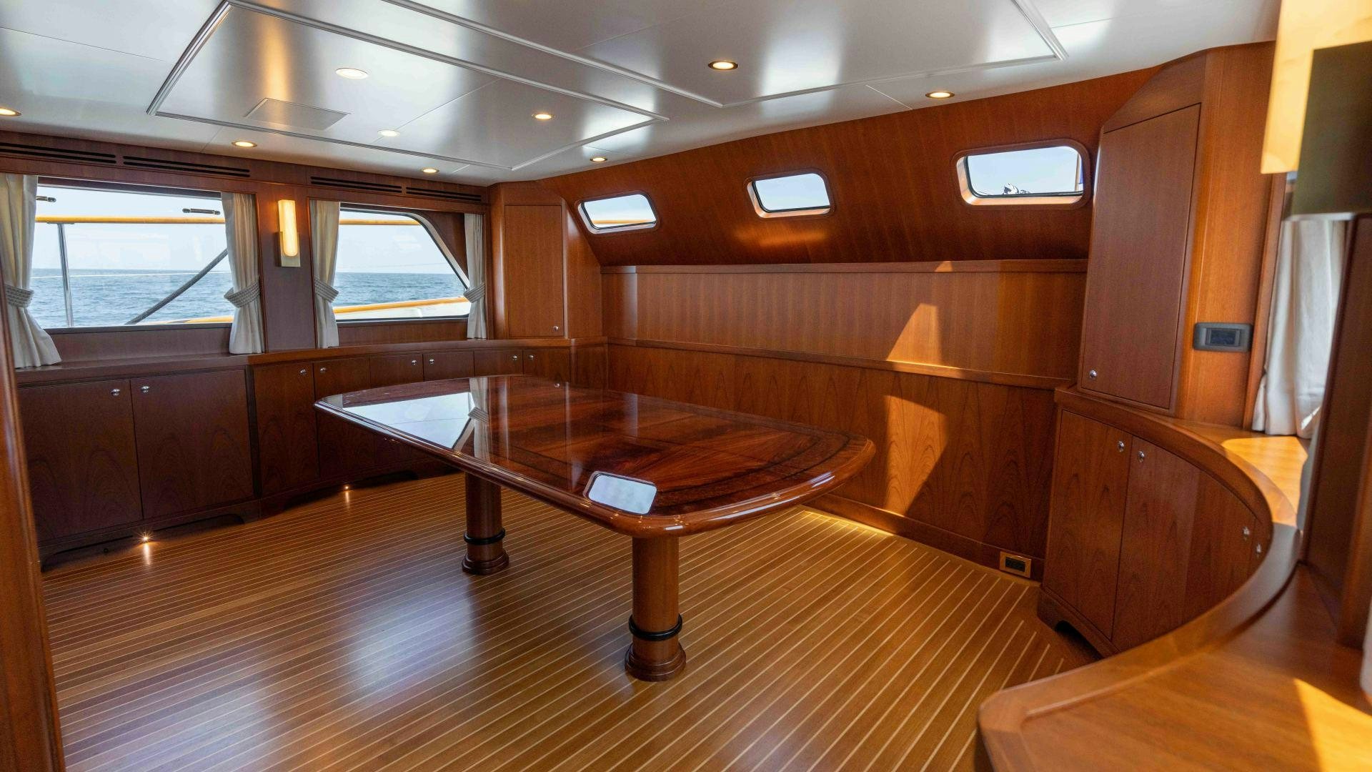 a room with a table and chairs aboard NEREUS Yacht for Sale