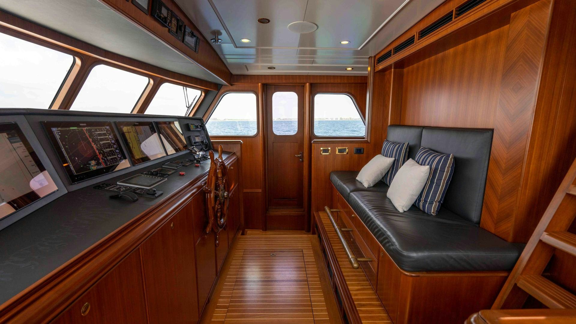 a room with a couch and a table aboard NEREUS Yacht for Sale