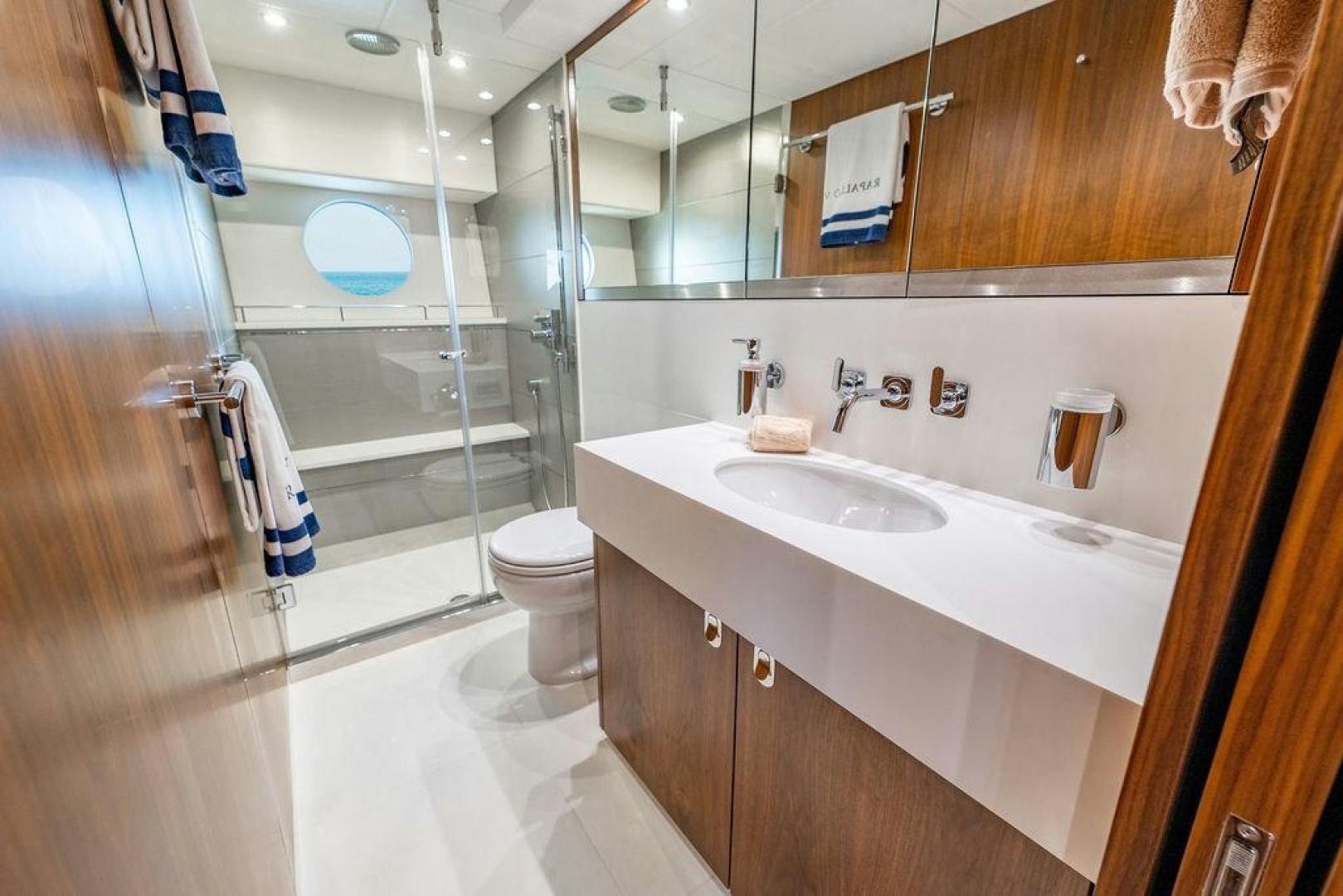a bathroom with a glass shower aboard RAPALLO V Yacht for Sale