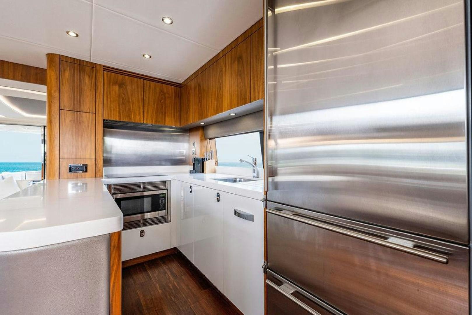 a kitchen with wooden cabinets aboard RAPALLO V Yacht for Sale