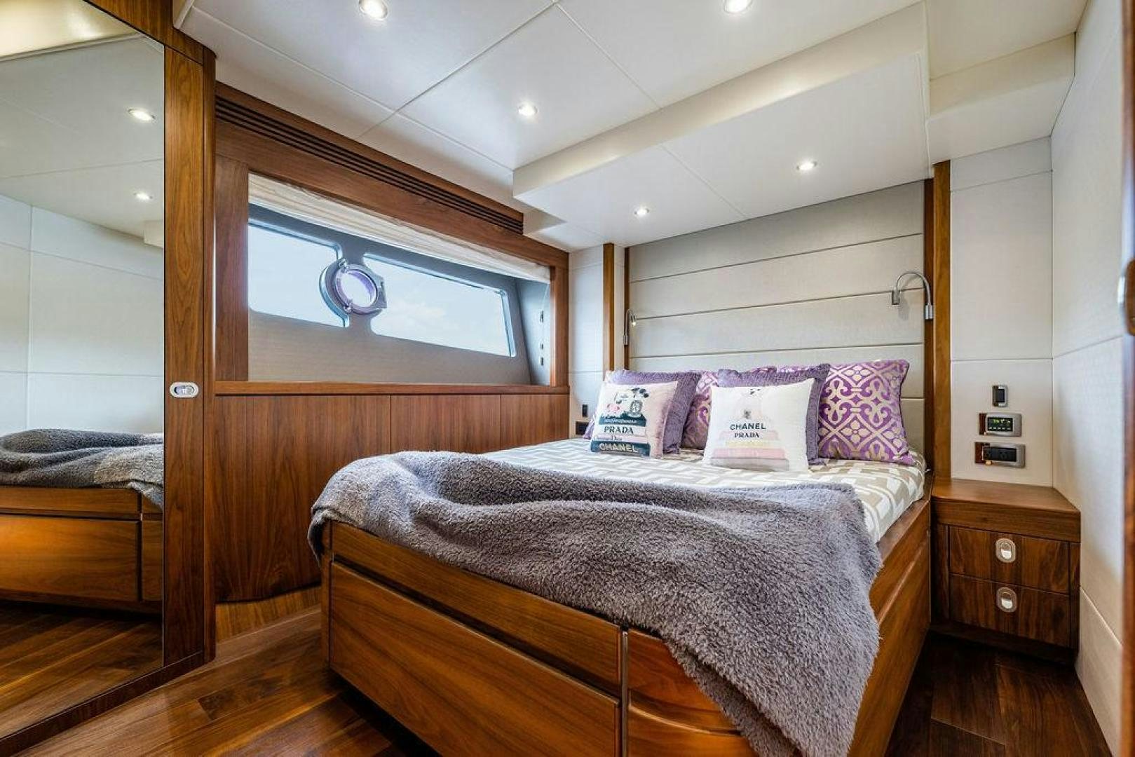 a bed with a wooden headboard aboard RAPALLO V Yacht for Sale