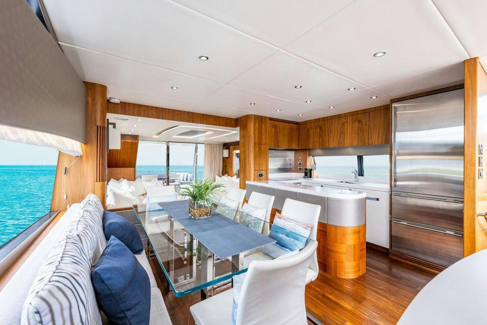 a room with a table chairs and a couch aboard RAPALLO V Yacht for Sale