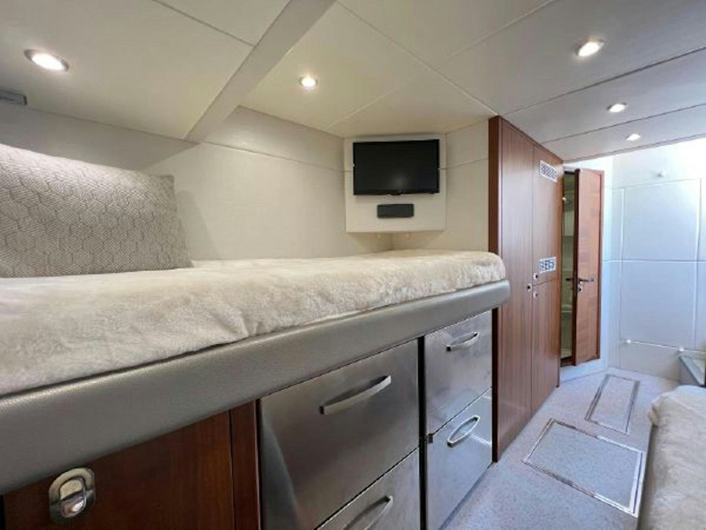 a bedroom with a bed and a television aboard RAPALLO V Yacht for Sale