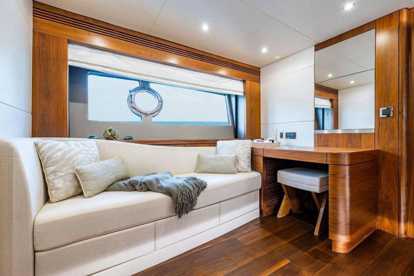 a living room with a white couch aboard RAPALLO V Yacht for Sale