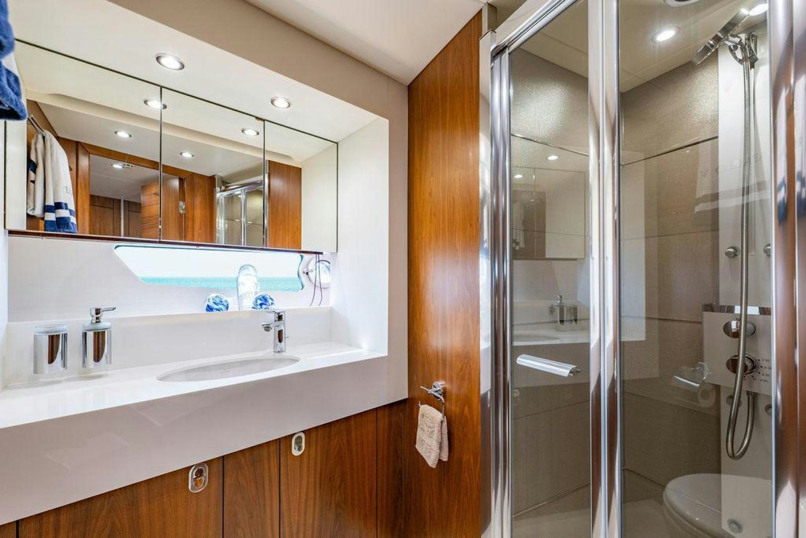 a bathroom with a glass shower aboard RAPALLO V Yacht for Sale