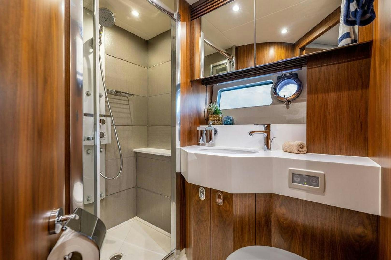 a bathroom with a glass shower aboard RAPALLO V Yacht for Sale