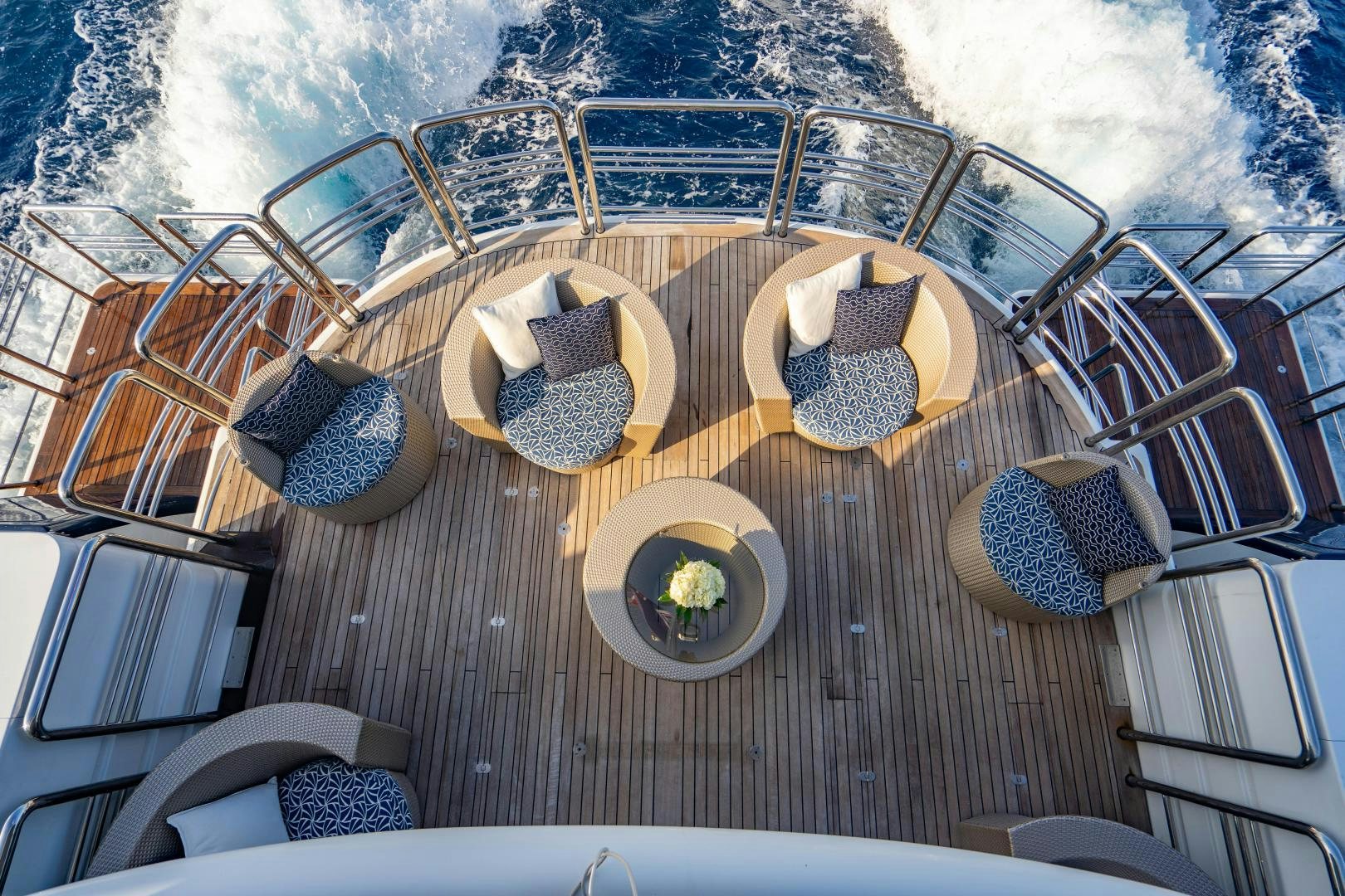 a deck with a table and chairs on it aboard MY SPIRIT Yacht for Sale
