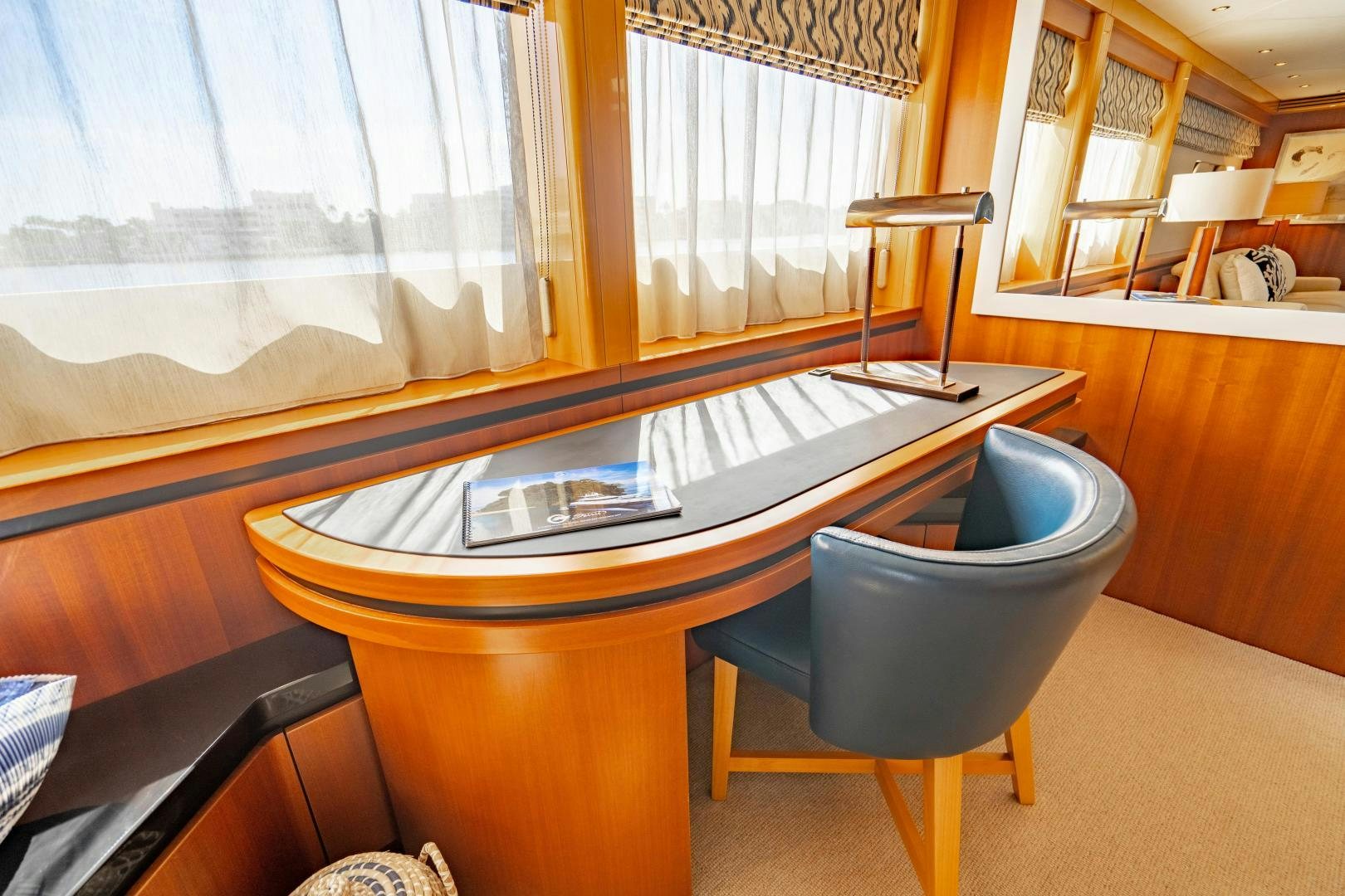 a table with a chair and a chair in a room with a window aboard MY SPIRIT Yacht for Sale