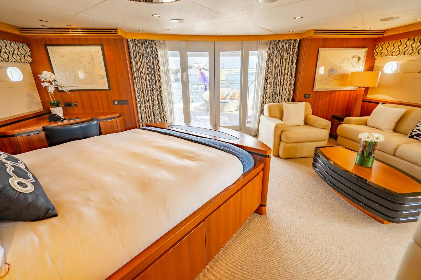 a large bedroom with a bed and a coffee table aboard MY SPIRIT Yacht for Sale