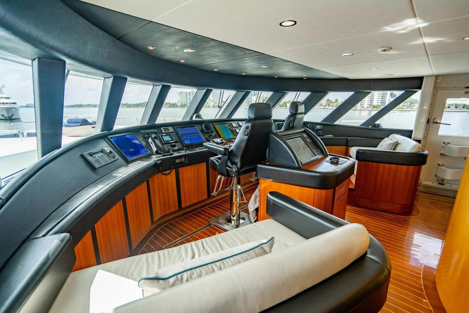 inside of a car with a large window and a seat and a desk with a computer on it aboard MY SPIRIT Yacht for Sale