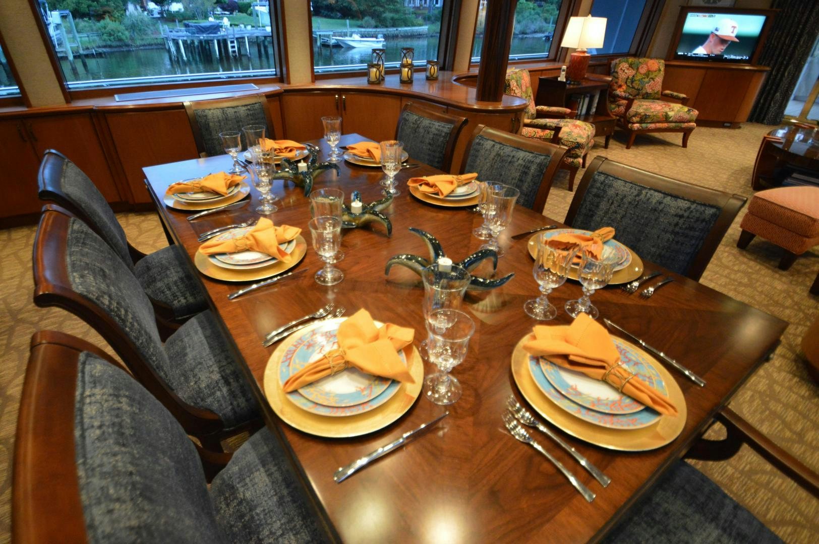 a table with plates and glasses on it aboard MARBRI Yacht for Sale