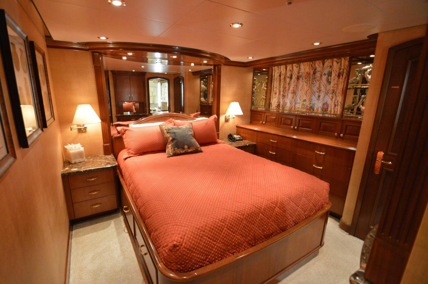 a bedroom with a bed and a dresser aboard MARBRI Yacht for Sale