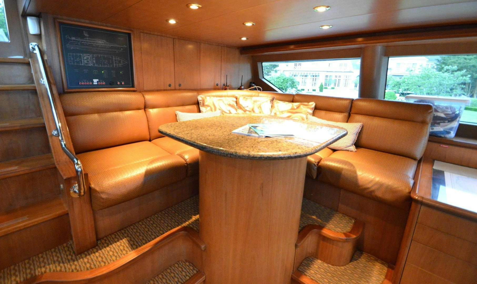 a living room with a table and couches aboard MARBRI Yacht for Sale