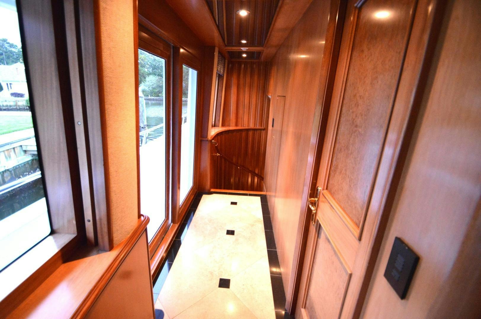 a hallway with wood walls aboard MARBRI Yacht for Sale
