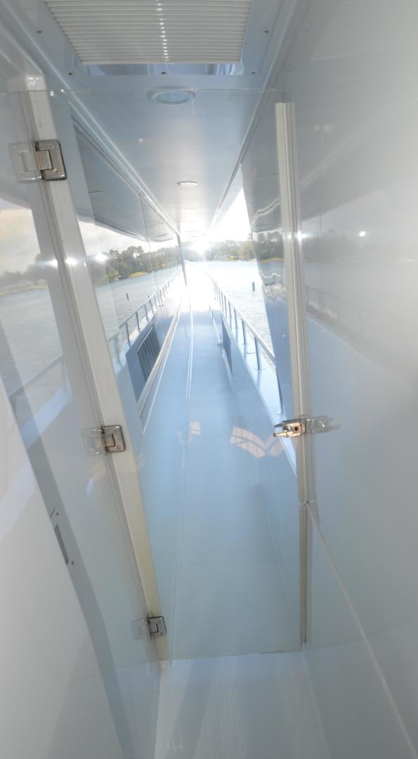 a hallway with glass doors aboard MARBRI Yacht for Sale