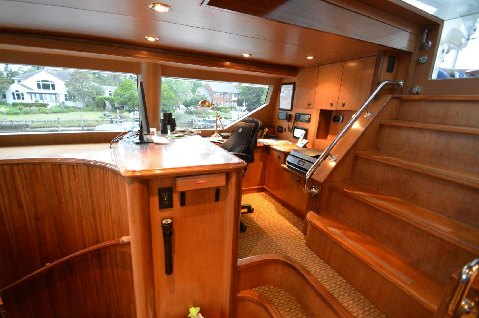 a wooden table with a chair and a laptop on it aboard MARBRI Yacht for Sale