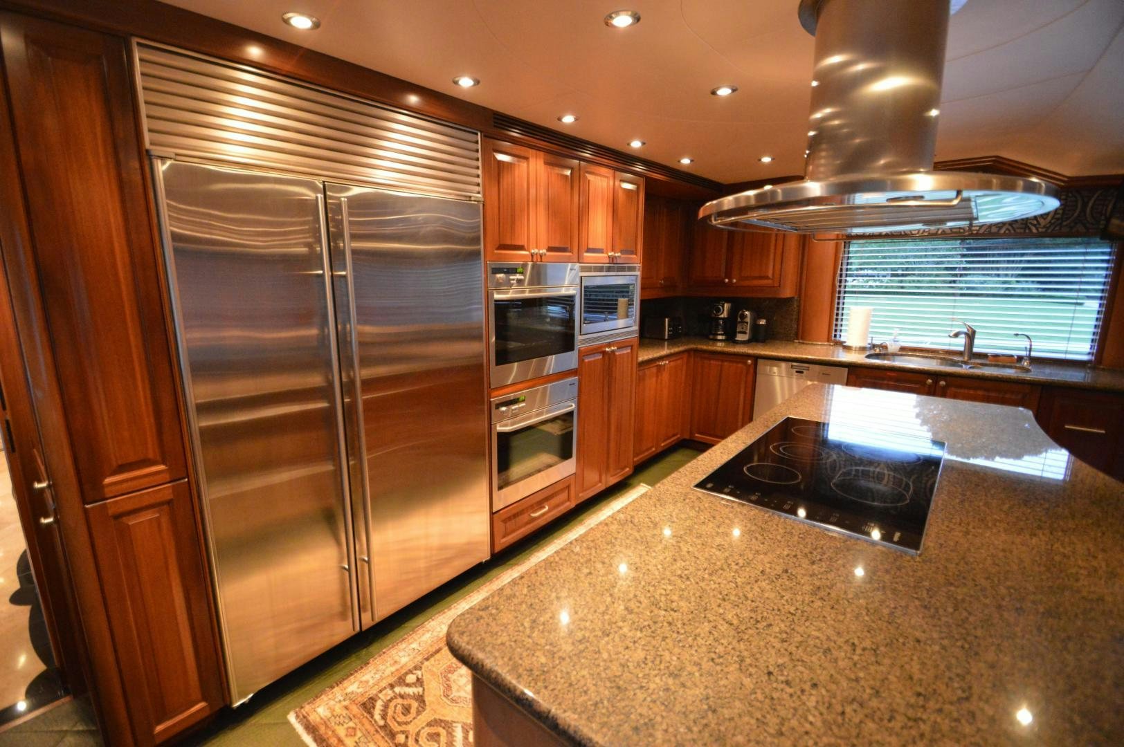 a kitchen with a stainless steel refrigerator aboard MARBRI Yacht for Sale