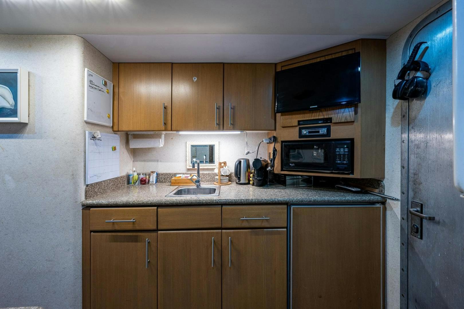 a kitchen with wooden cabinets aboard ATLANTIC Yacht for Sale