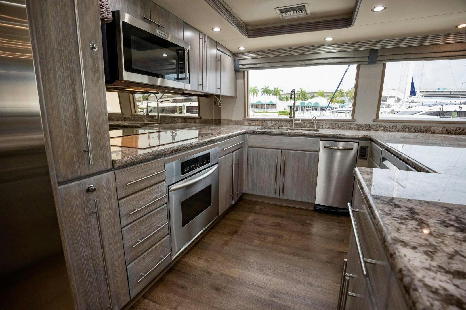 a kitchen with wooden cabinets aboard ATLANTIC Yacht for Sale