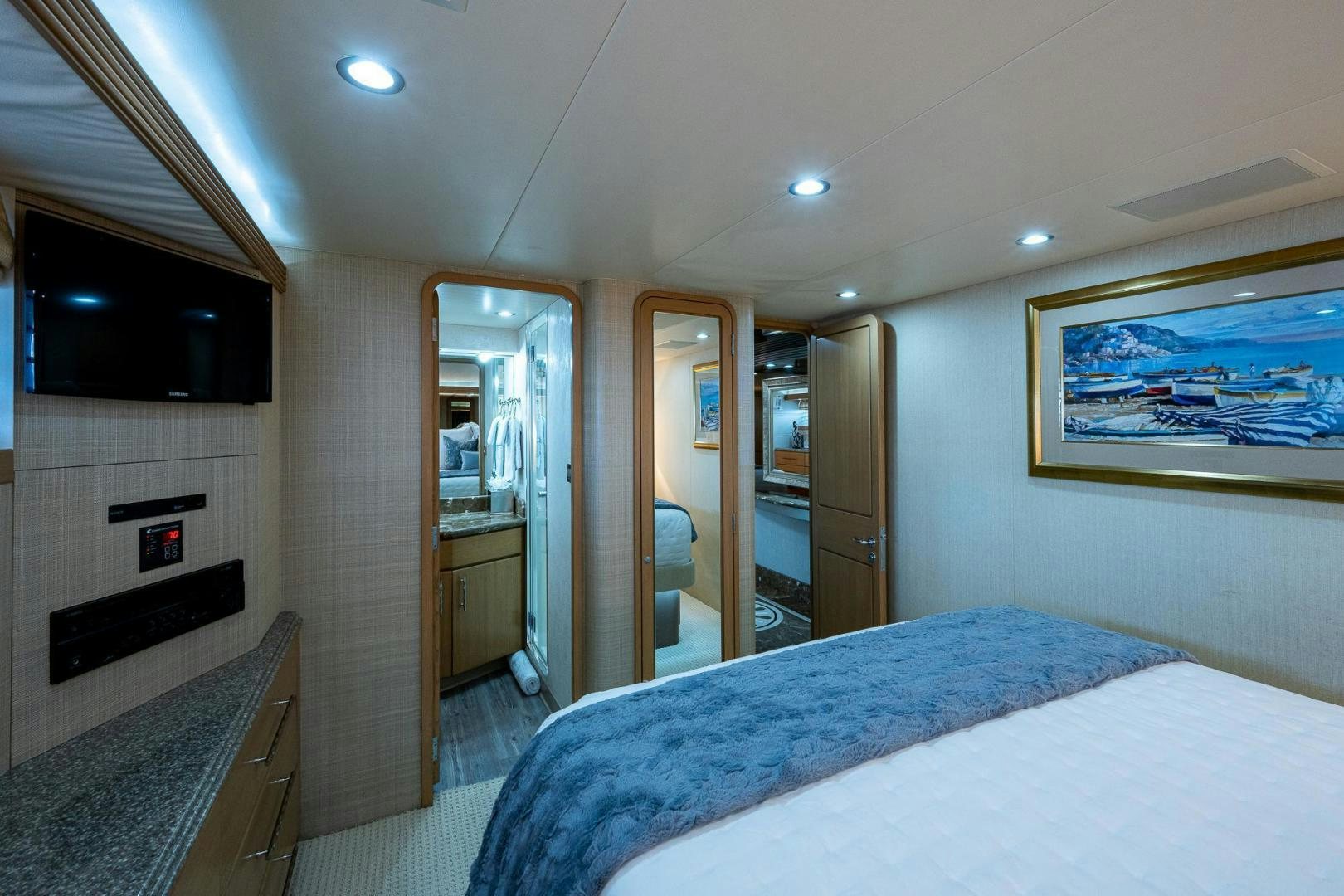 a bedroom with a bed and a fireplace aboard ATLANTIC Yacht for Sale