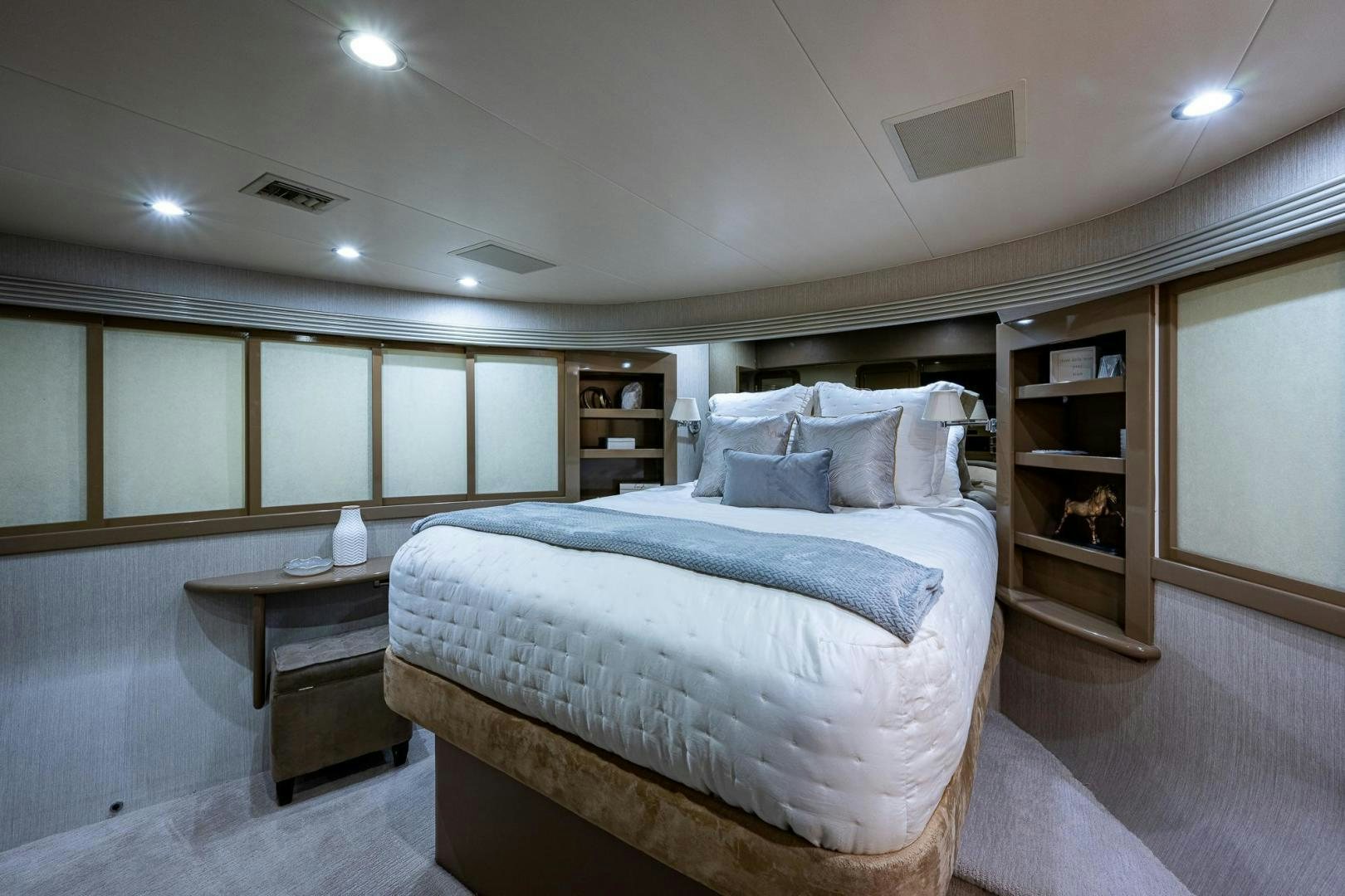 a bedroom with a bed and a bookcase aboard ATLANTIC Yacht for Sale