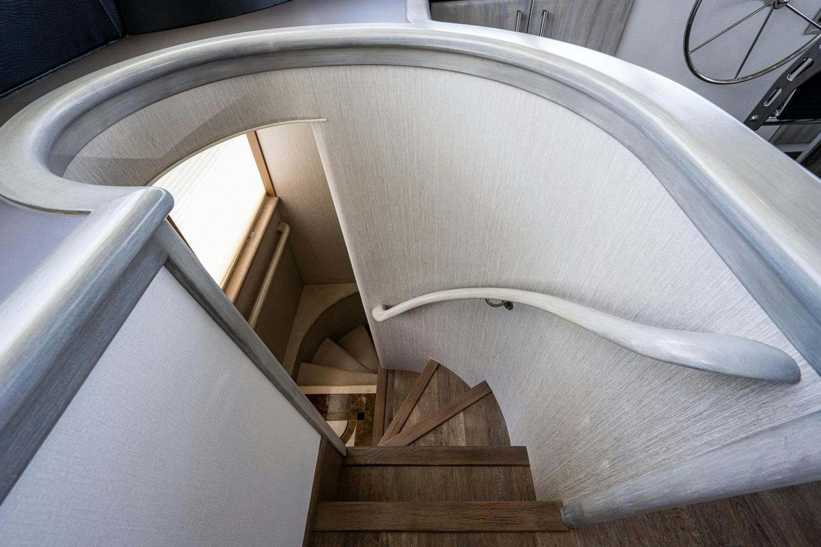 a white spiral staircase aboard ATLANTIC Yacht for Sale