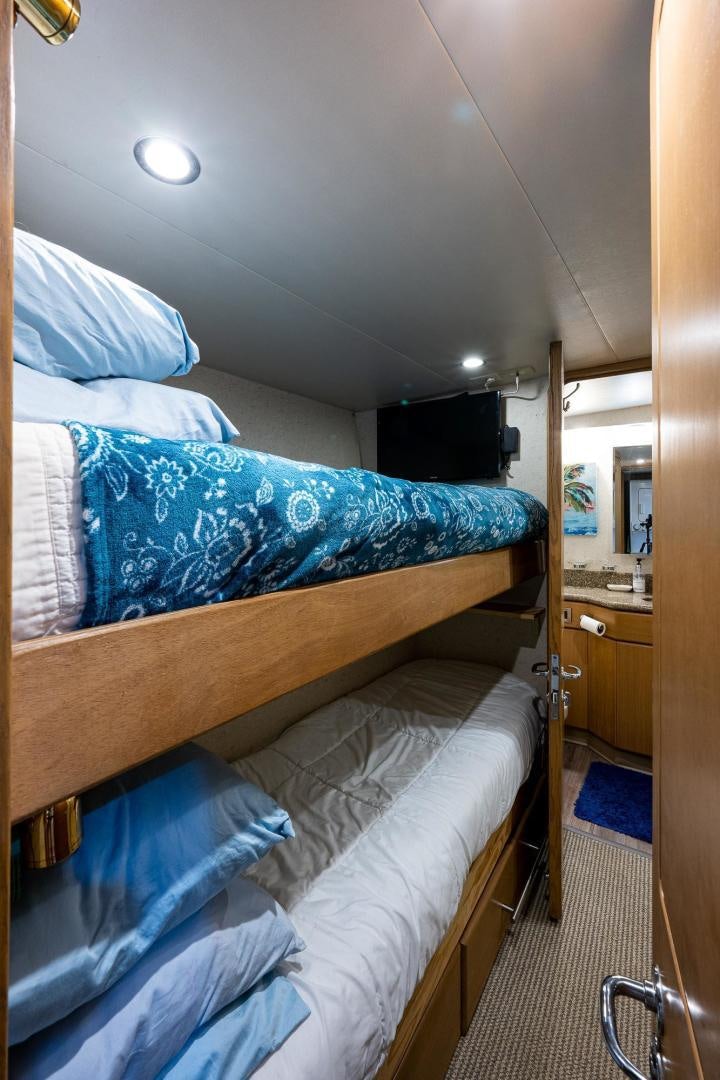 a bed with blue sheets aboard ATLANTIC Yacht for Sale