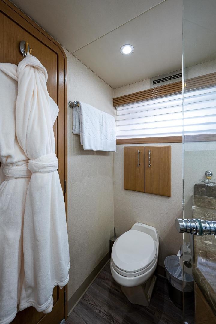 a bathroom with a toilet and towels aboard ATLANTIC Yacht for Sale