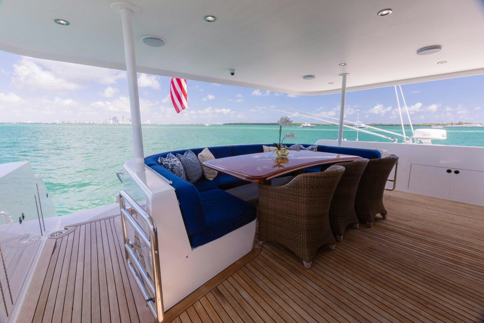 a room with a table and chairs on a deck overlooking the ocean aboard ATLANTIC Yacht for Sale
