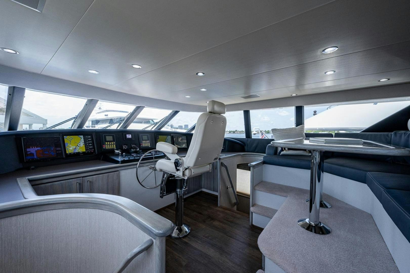 a room with a chair and a desk with chairs and a television aboard ATLANTIC Yacht for Sale