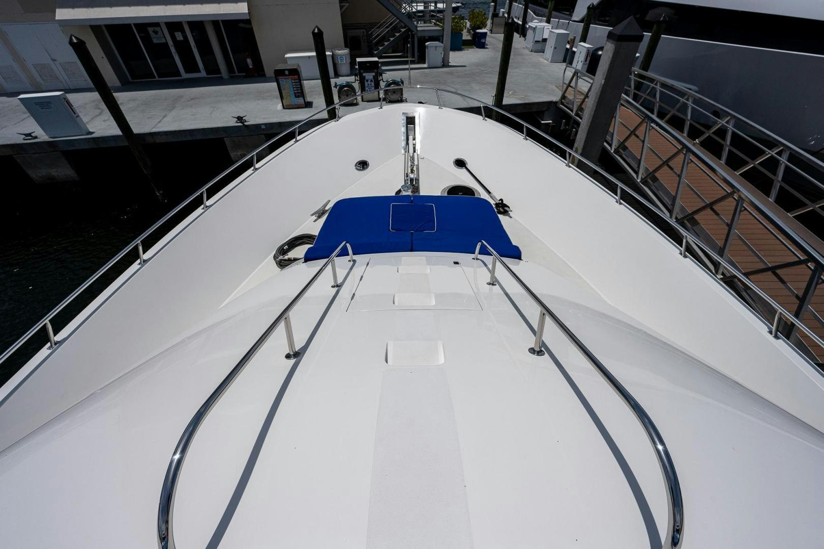 a large white building with a blue roof and a blue bench aboard ATLANTIC Yacht for Sale