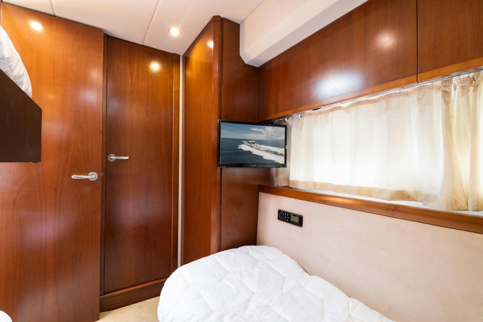 a bed and a television in a room aboard AMNESIA Yacht for Sale