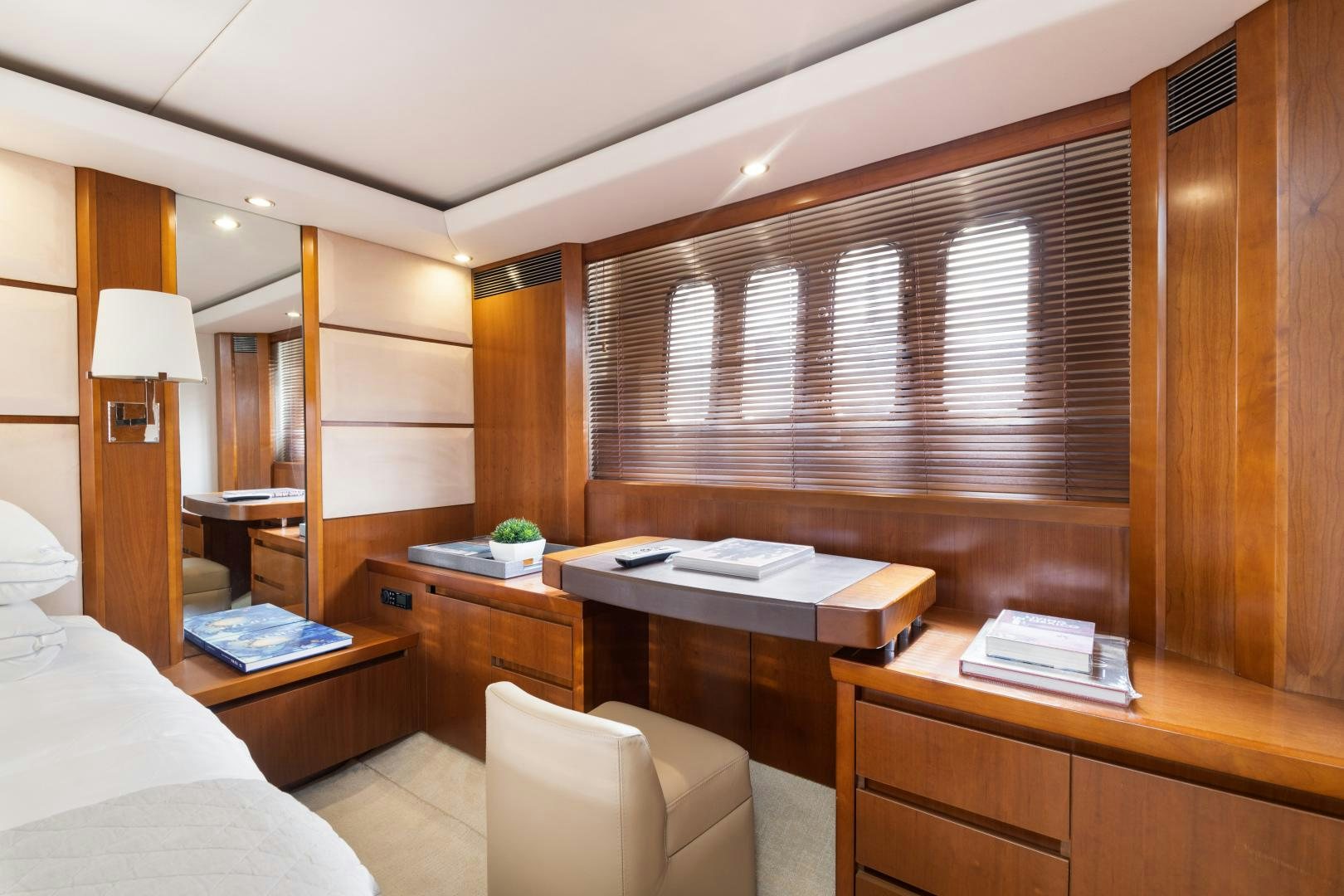 a bedroom with a desk and a bed aboard AMNESIA Yacht for Sale