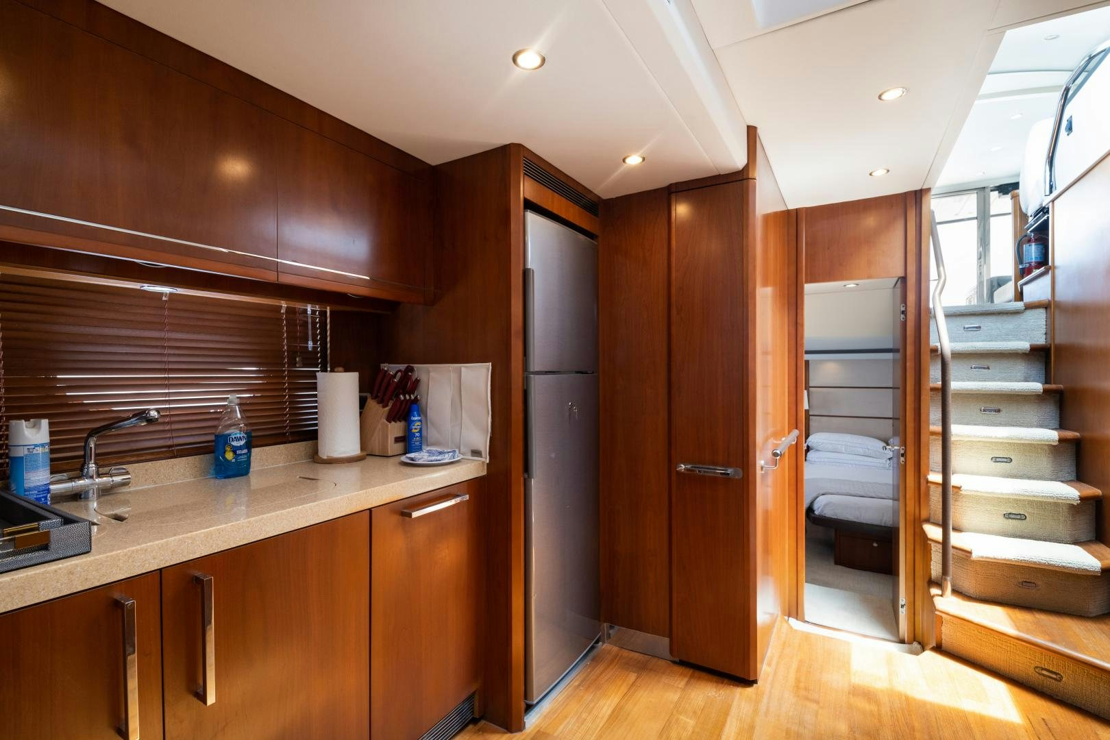 a room with wooden cabinets and a sink aboard AMNESIA Yacht for Sale