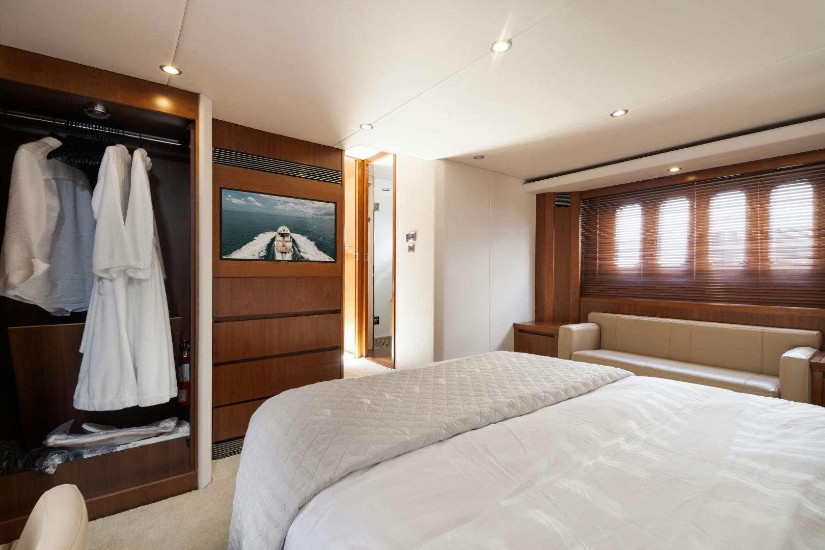 a bedroom with a bed and a television aboard AMNESIA Yacht for Sale