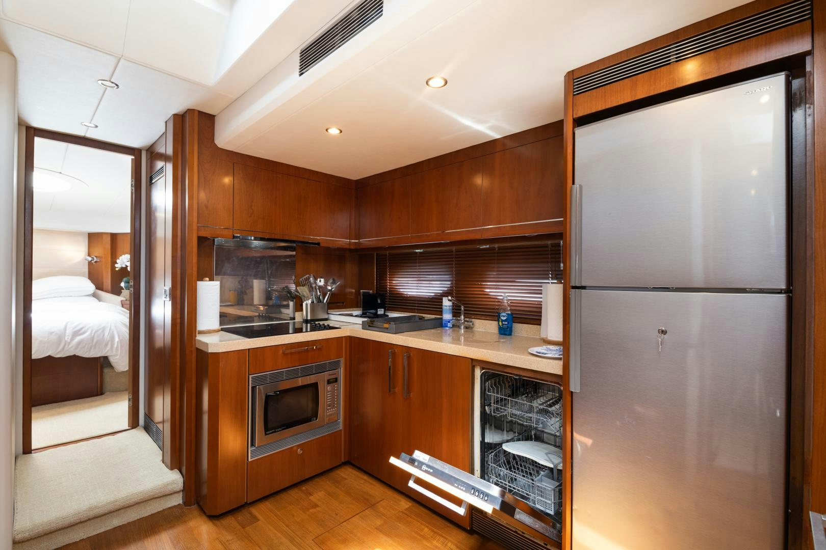 a kitchen with a refrigerator and a sink aboard AMNESIA Yacht for Sale
