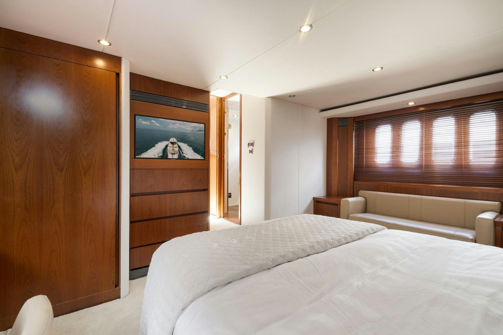 a bedroom with a bed and a television aboard AMNESIA Yacht for Sale