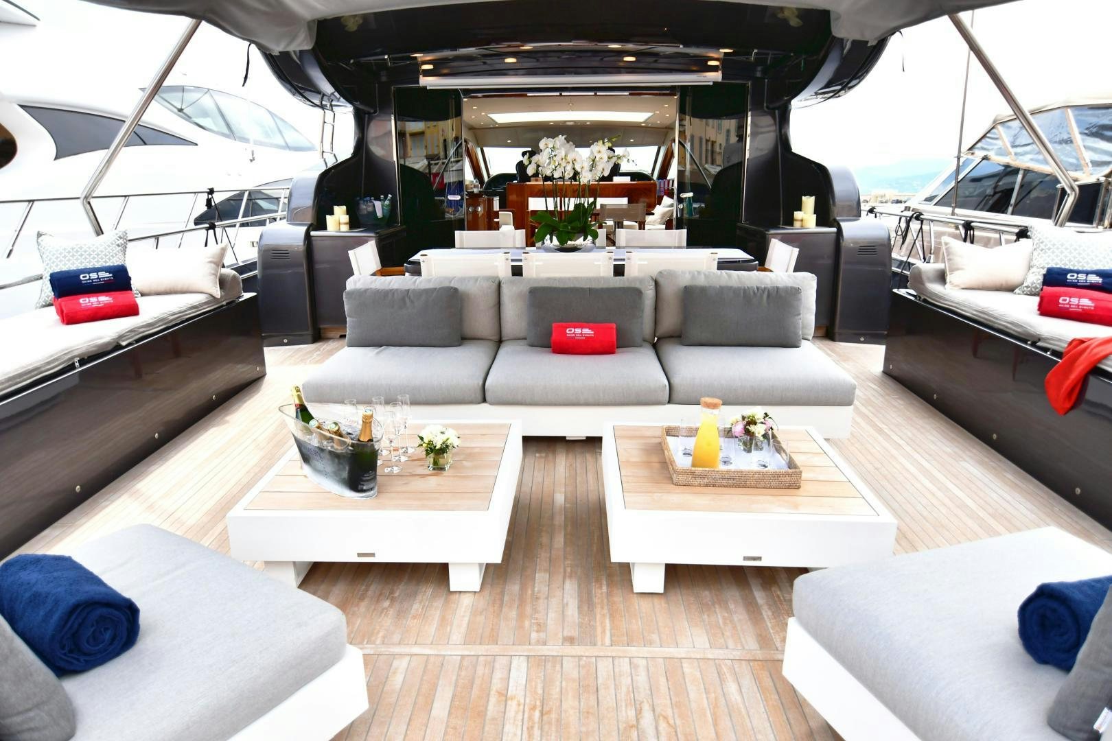 a living room with a large white couch and a wood floor aboard OSE Yacht for Sale