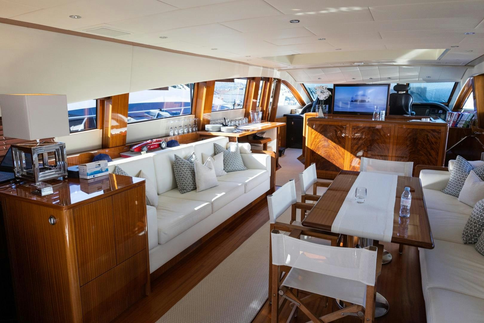 a room with a couch and a table and a television aboard OSE Yacht for Sale