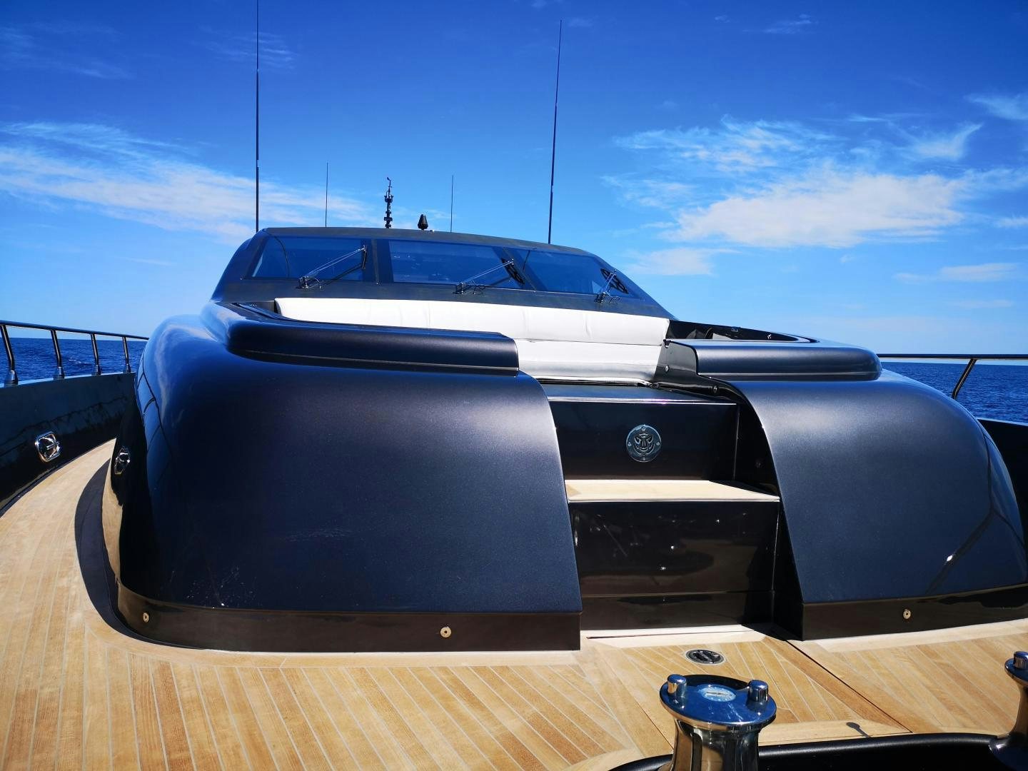 a black and white car on a wooden deck aboard OSE Yacht for Sale