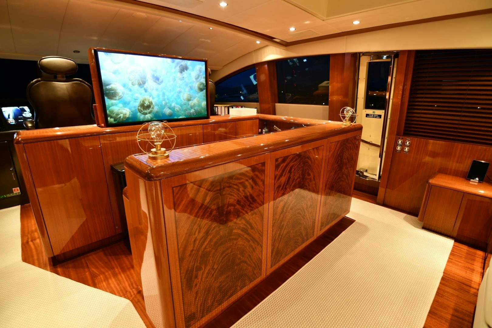 a room with a tv and a table aboard OSE Yacht for Sale