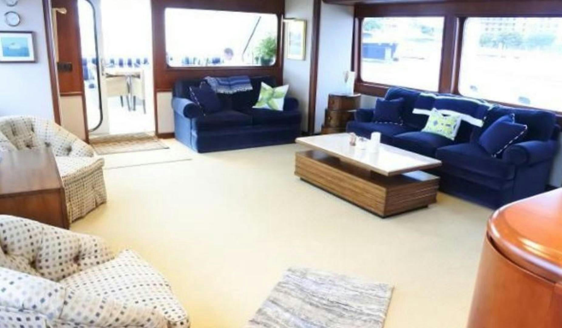 a living room with a couch and a coffee table aboard MY LADY ALASKA Yacht for Sale